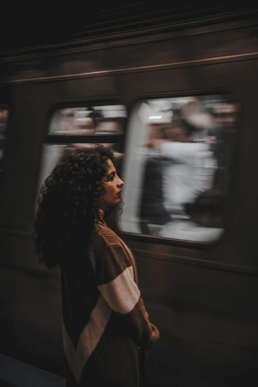 the black woman is waiting for the train to arrive