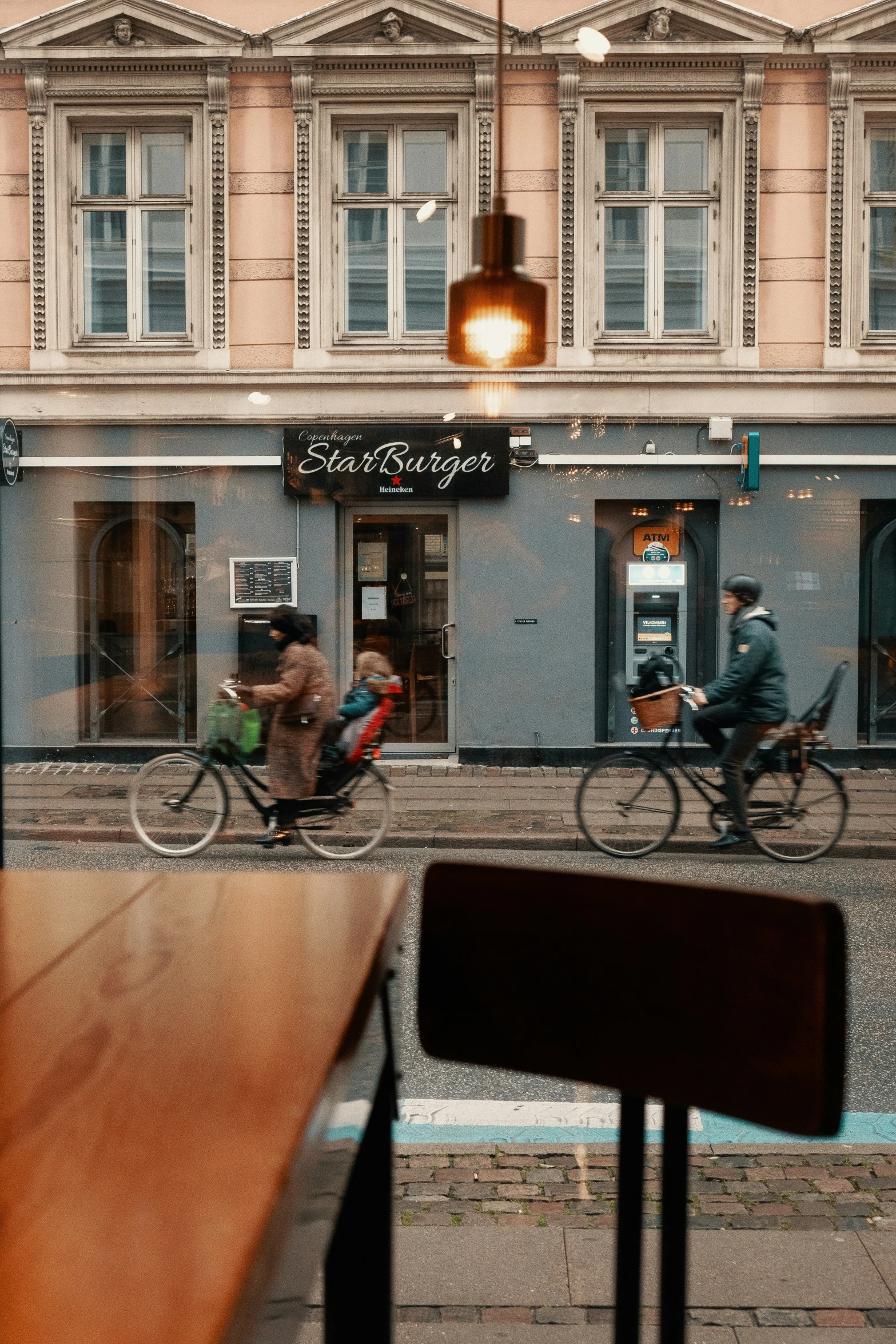 people riding bikes in a city street at night