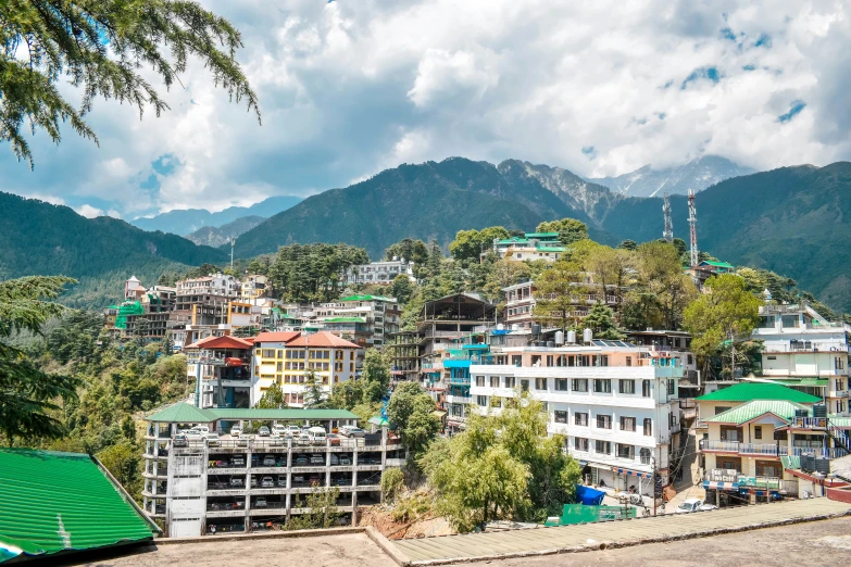 a small mountain town with many houses and mountains behind