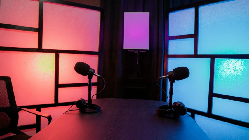 an empty room with a microphone next to a table