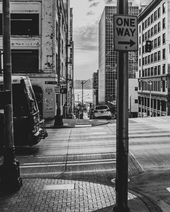 a one way street sign is on a metal pole