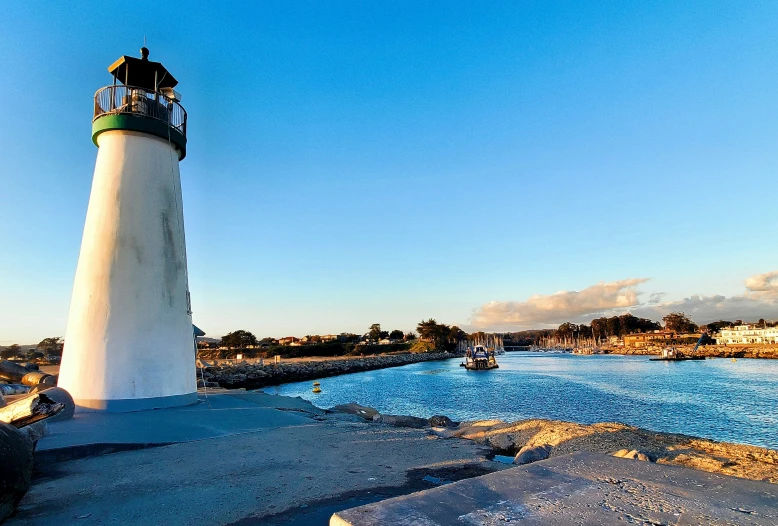 a white lighthouse with a black tower on it