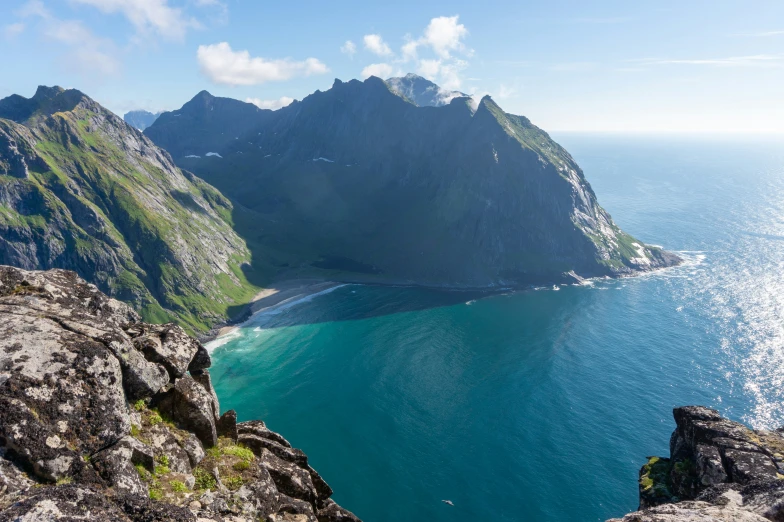 a large mountain with green grass on it