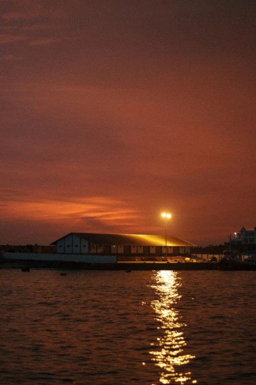 the sun sets over an island off the coast