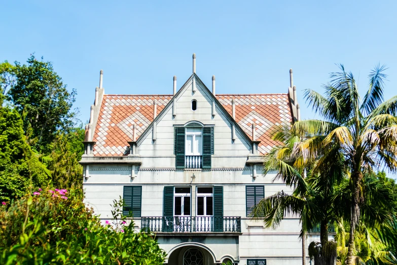 an old white house with a red tile roof and window