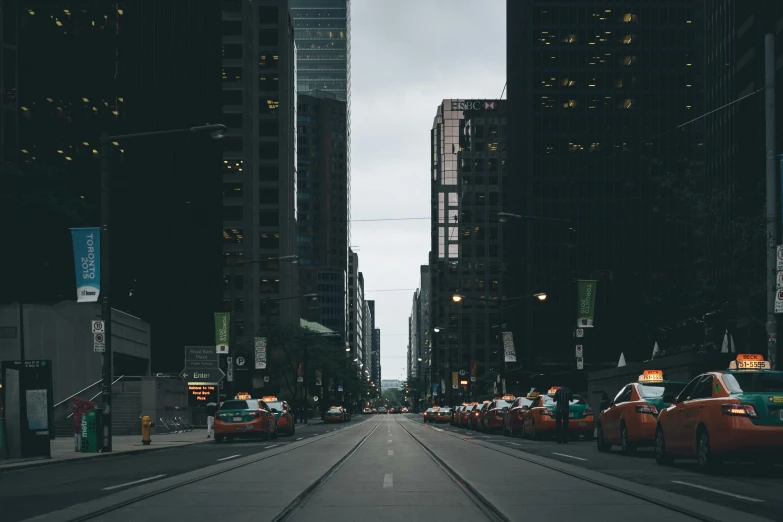 this po shows an empty city street with a row of parked vehicles