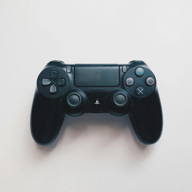 a close up of a black playstation remote