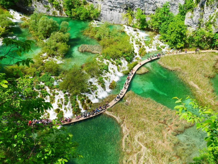 a bridge over the water leading to waterfalls