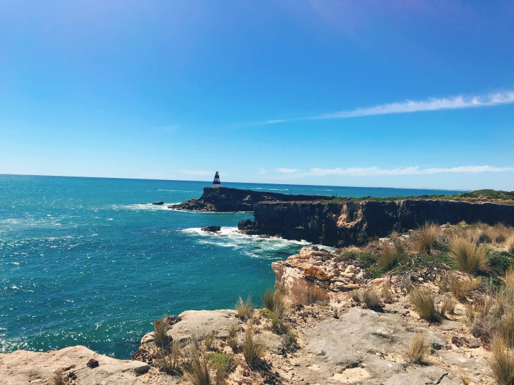 a rocky cliff over looking a body of water