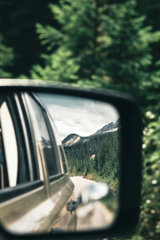 the view of the side mirror of a car