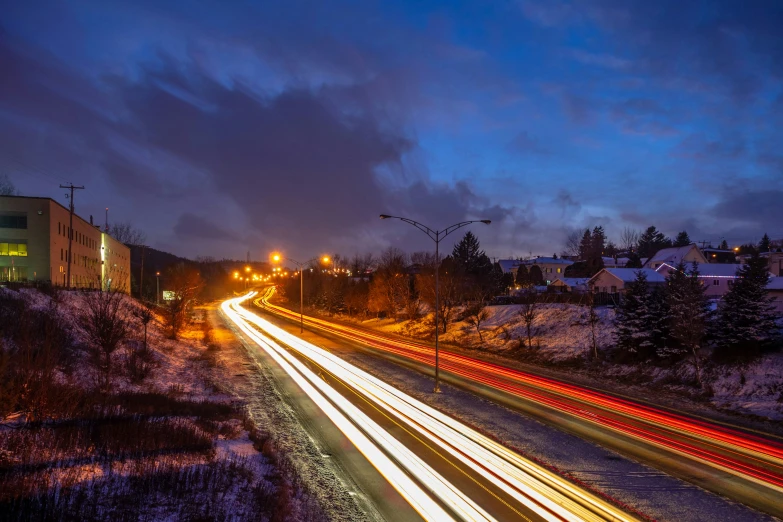 the night is lit up by cars passing the street