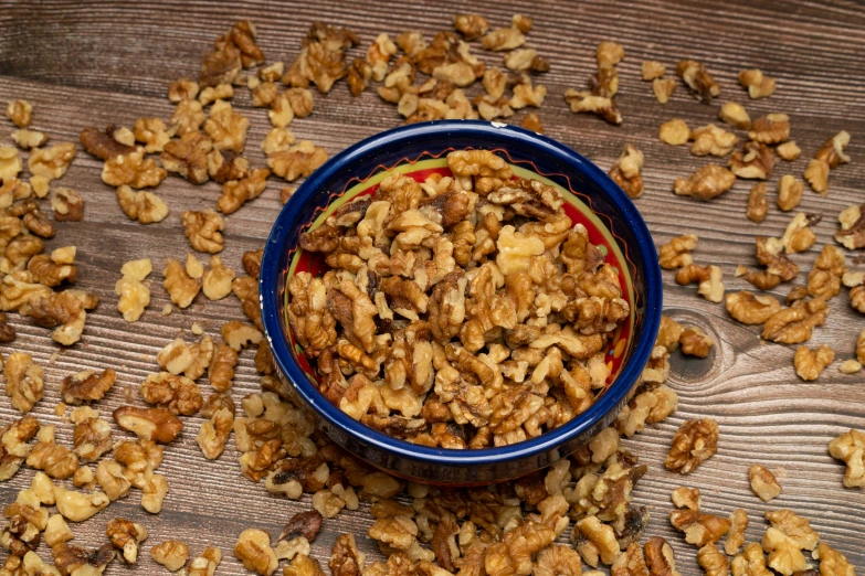 a bowl full of granola on top of a wooden table