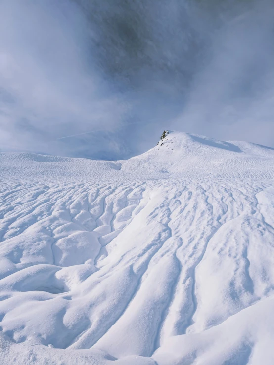 a person riding skis down a snowy hill