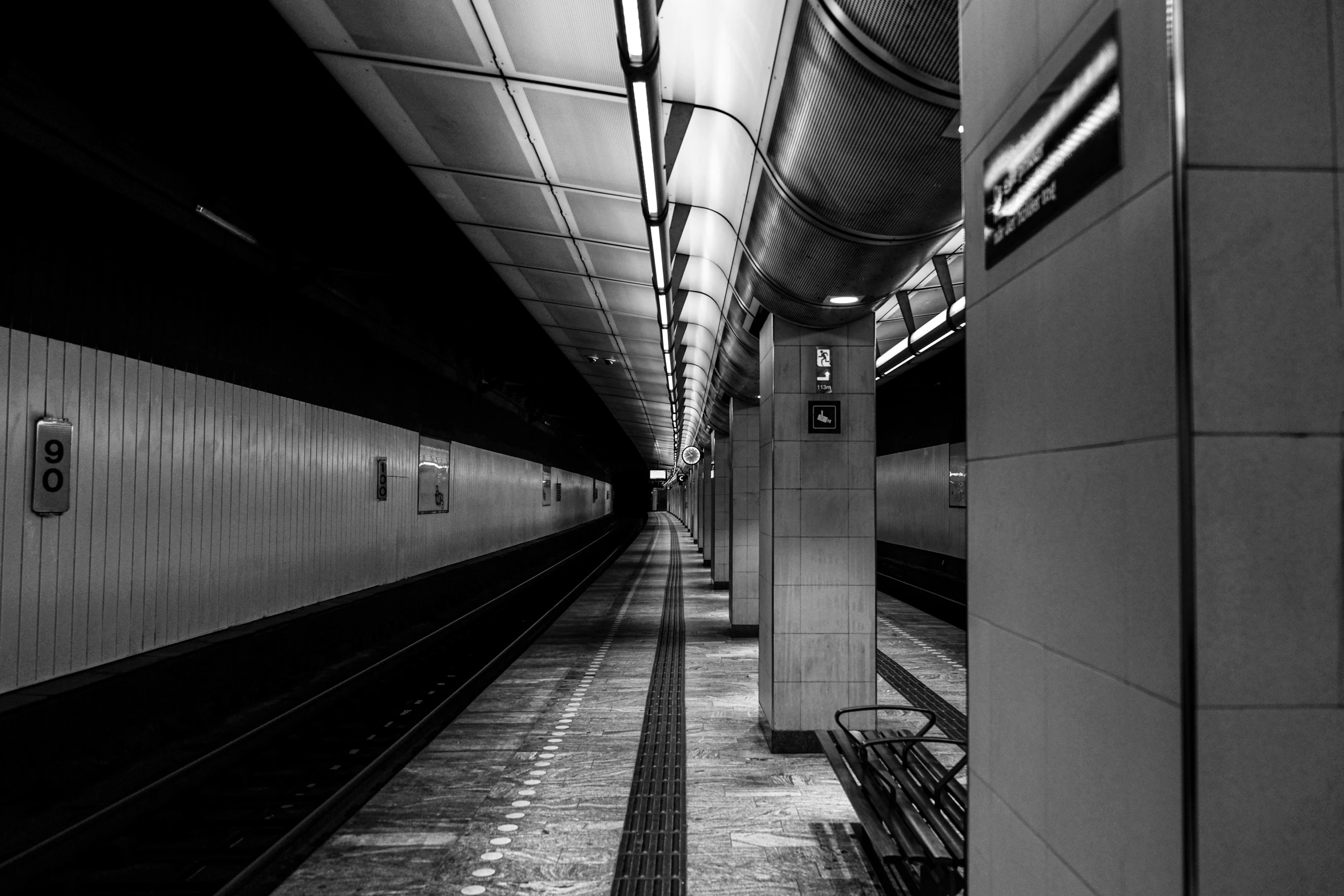 an empty subway station with one empty subway station