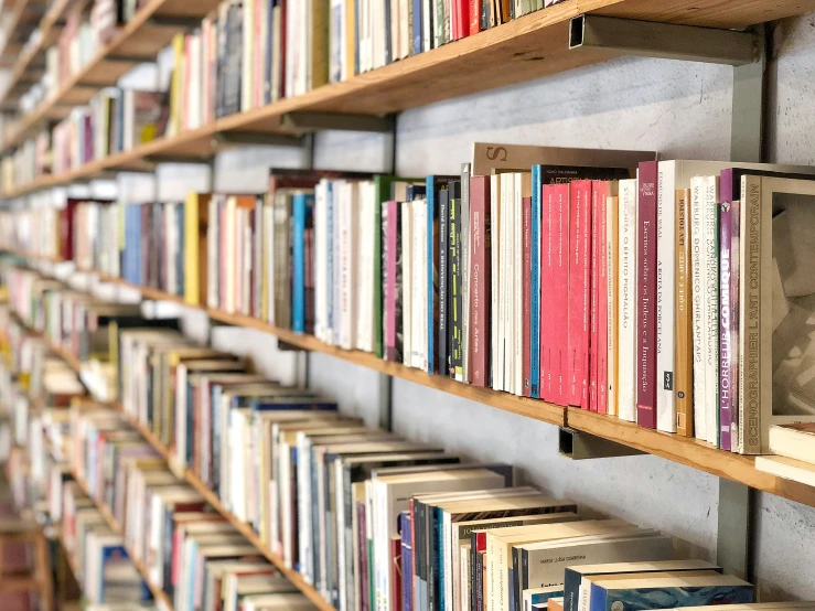 the bookcase is filled with books in the liry