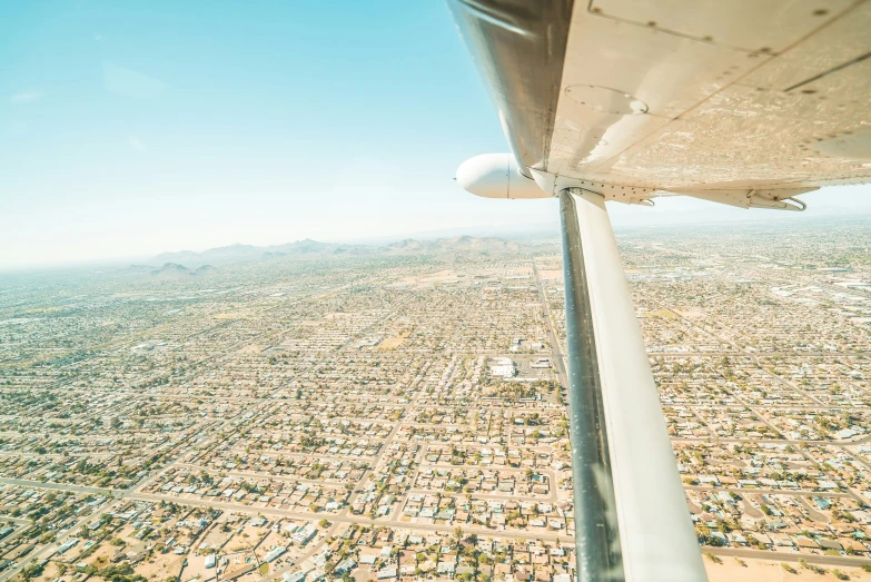 a city is seen through an airplane window