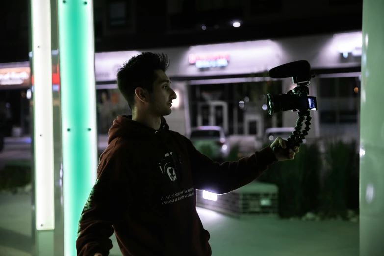 a man with a camera is seen in the dark