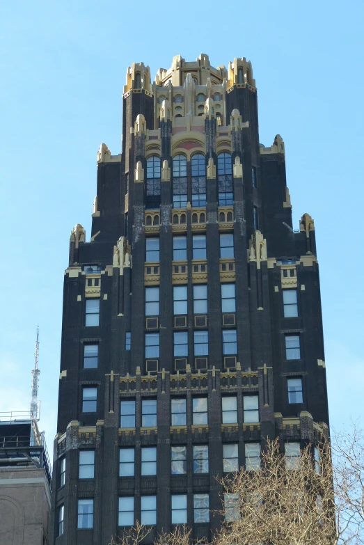 a tall black building with many windows and a clock