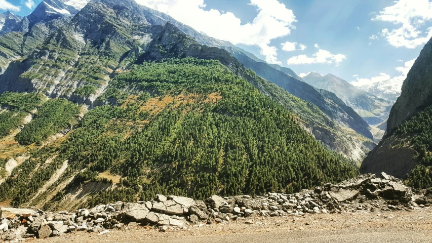 a large mountain with rocks on the ground