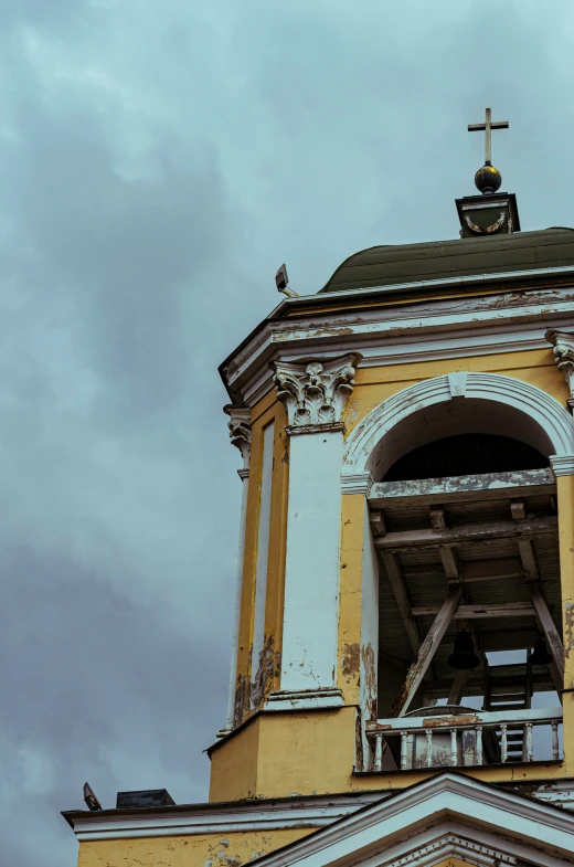 a cross sits atop the top of a building