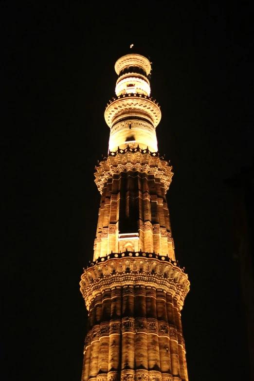 a tall tower with several windows and lights lit up