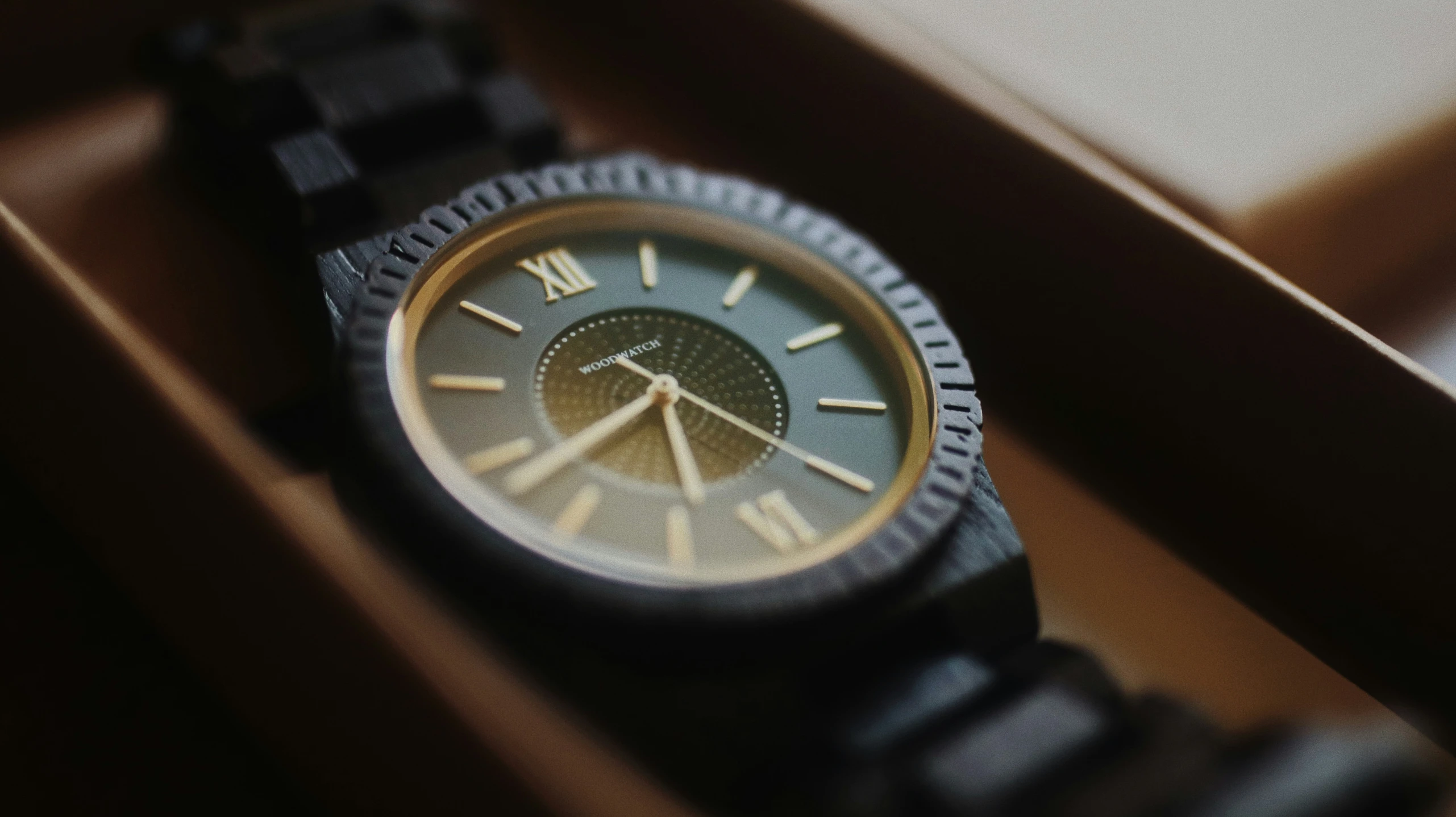 a watch is sitting in a box, showing its time