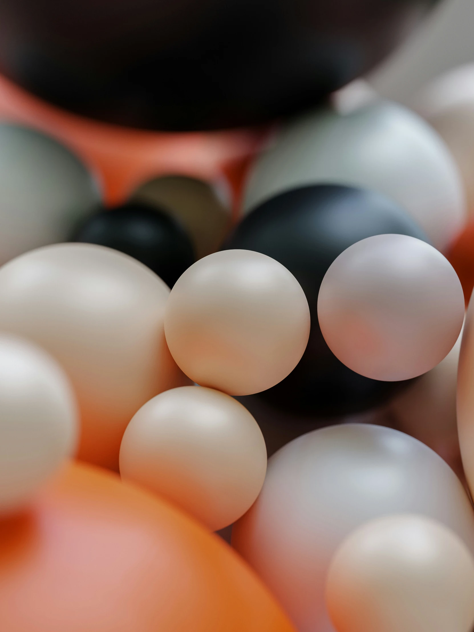 a bowl full of white, black and orange balloons