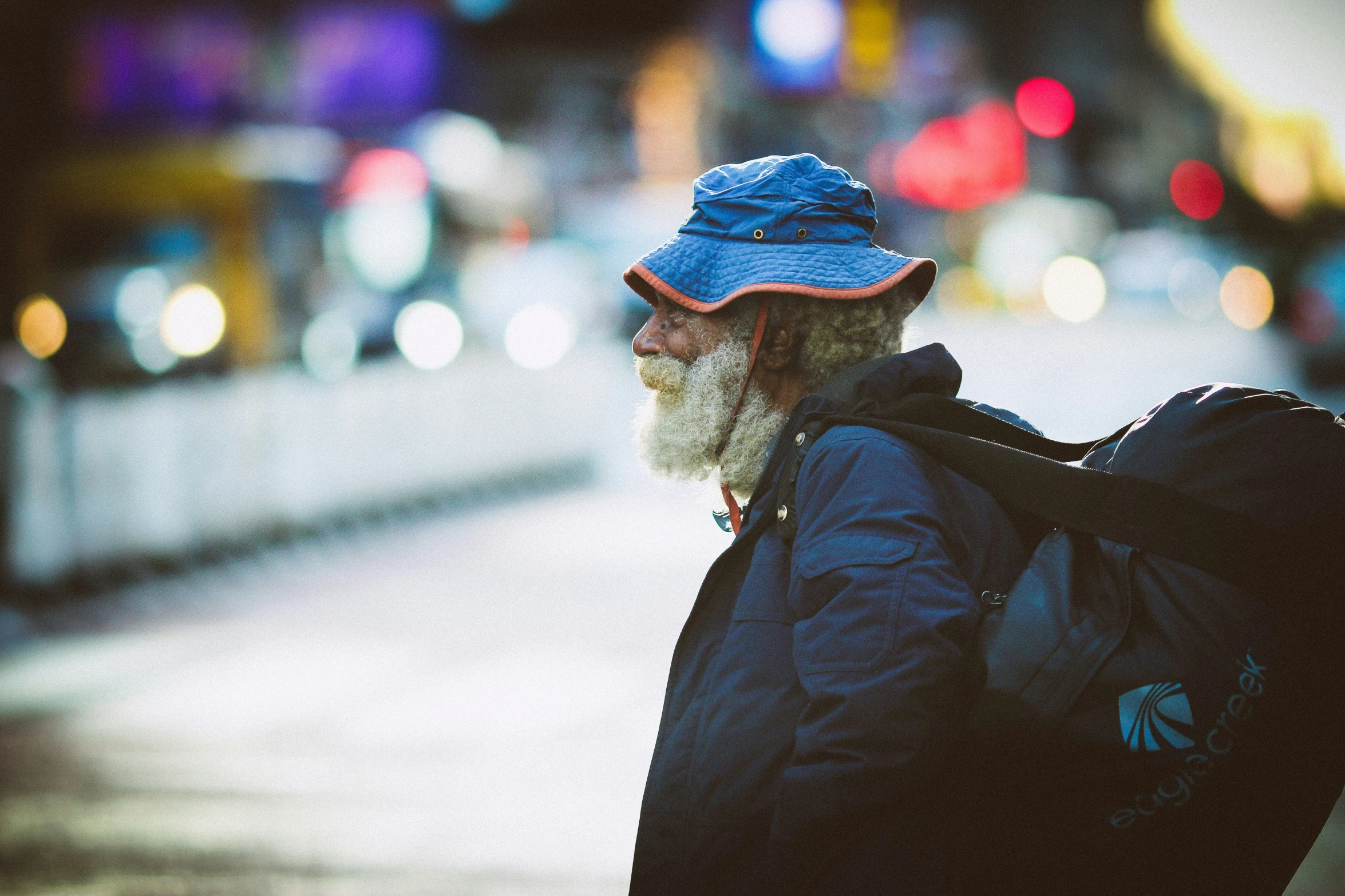 bearded homeless man walking with a suitcase