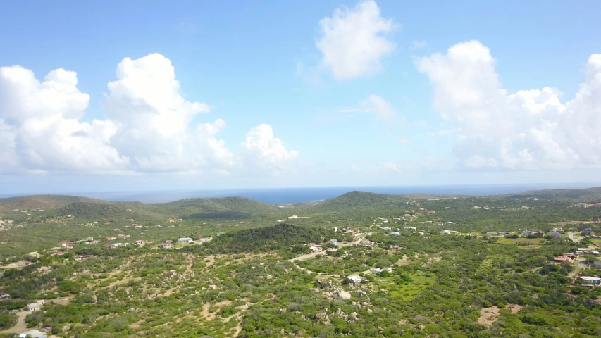 a scenic rural area is in the foreground and a coastal background