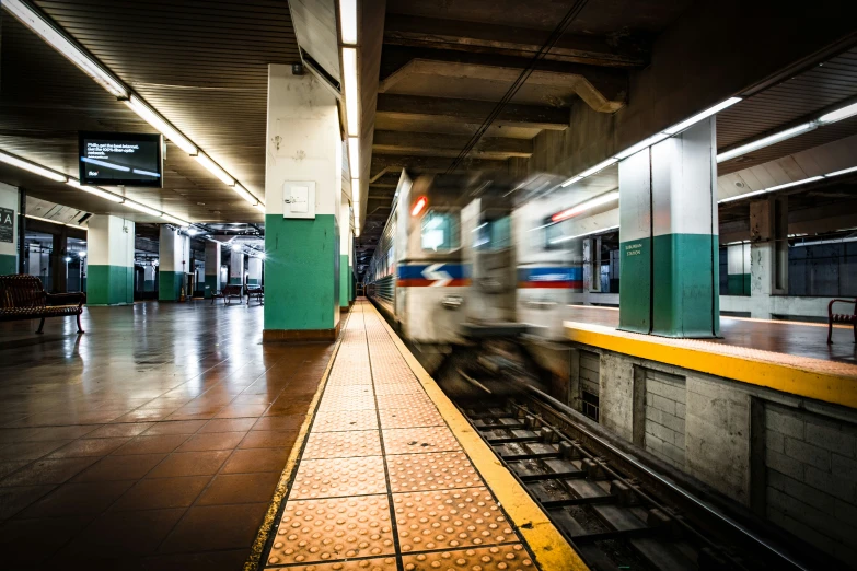 the train is traveling through the station to take the next destination