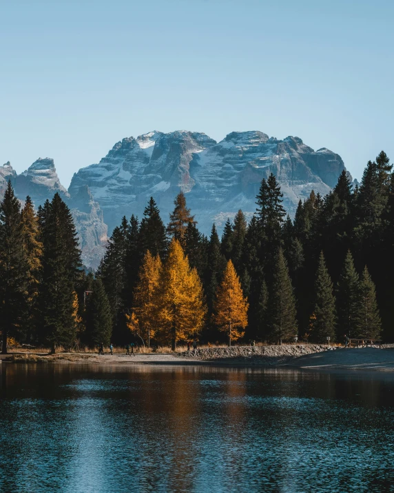 an area with a lake in front of the mountains