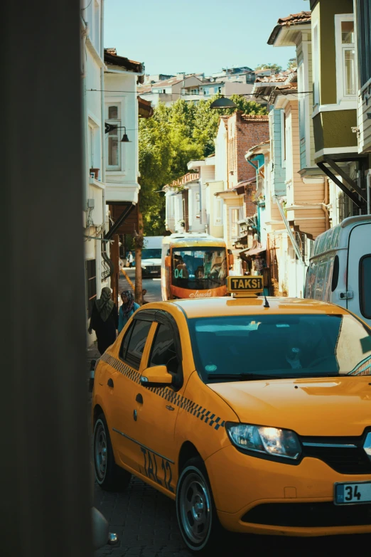 a yellow cab with black taxis and other vehicles