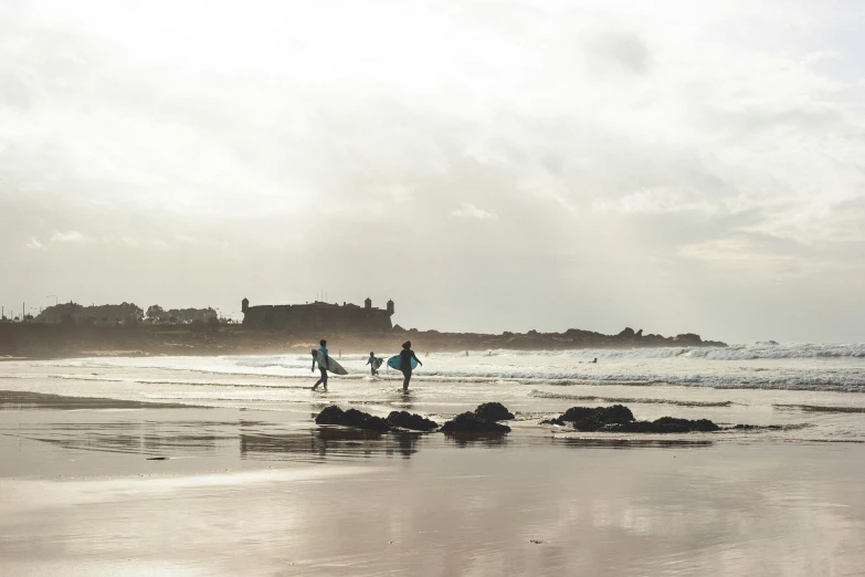 two men walking along a beach holding hands