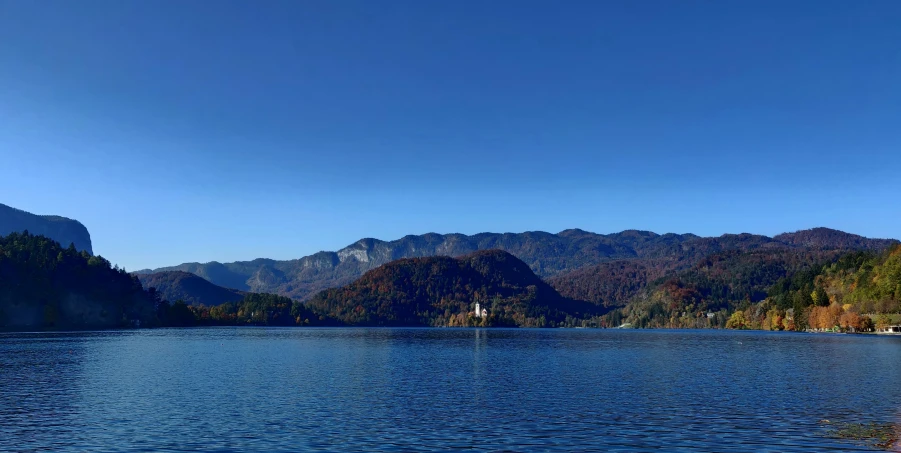 a lake surrounded by mountains and forests