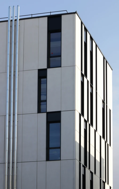 a tall building with lots of windows near other buildings