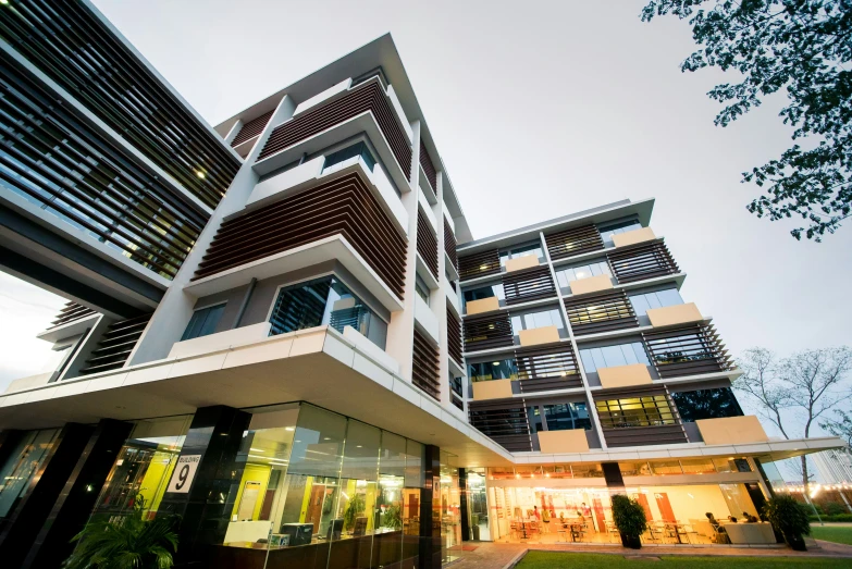 a modern high rise apartment building illuminated at night