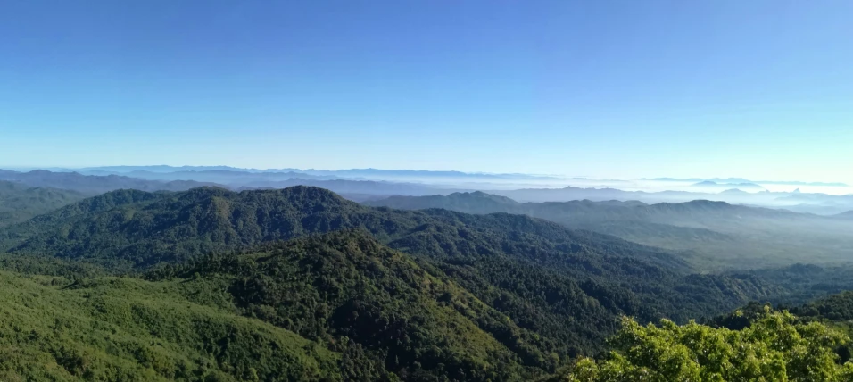 mountains are shown surrounded by blue sky and clouds