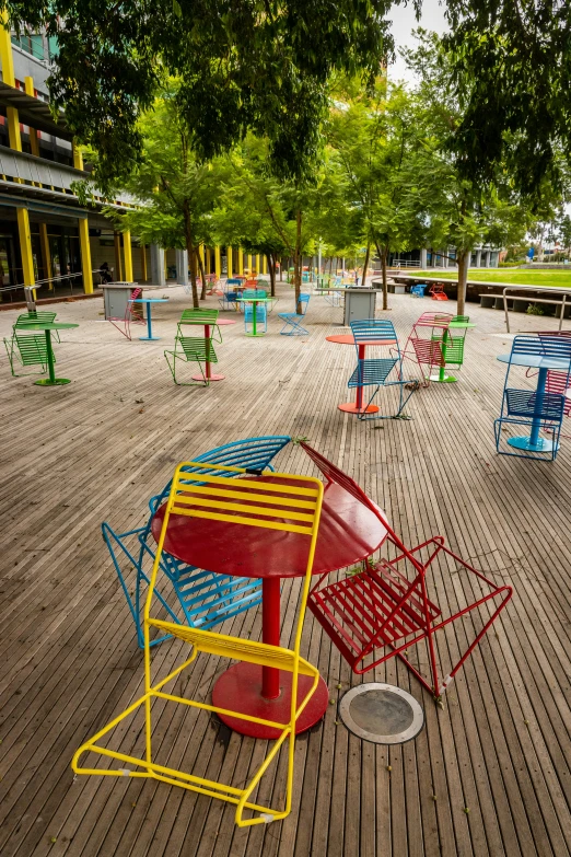 a couple of colorful chairs are on a large deck