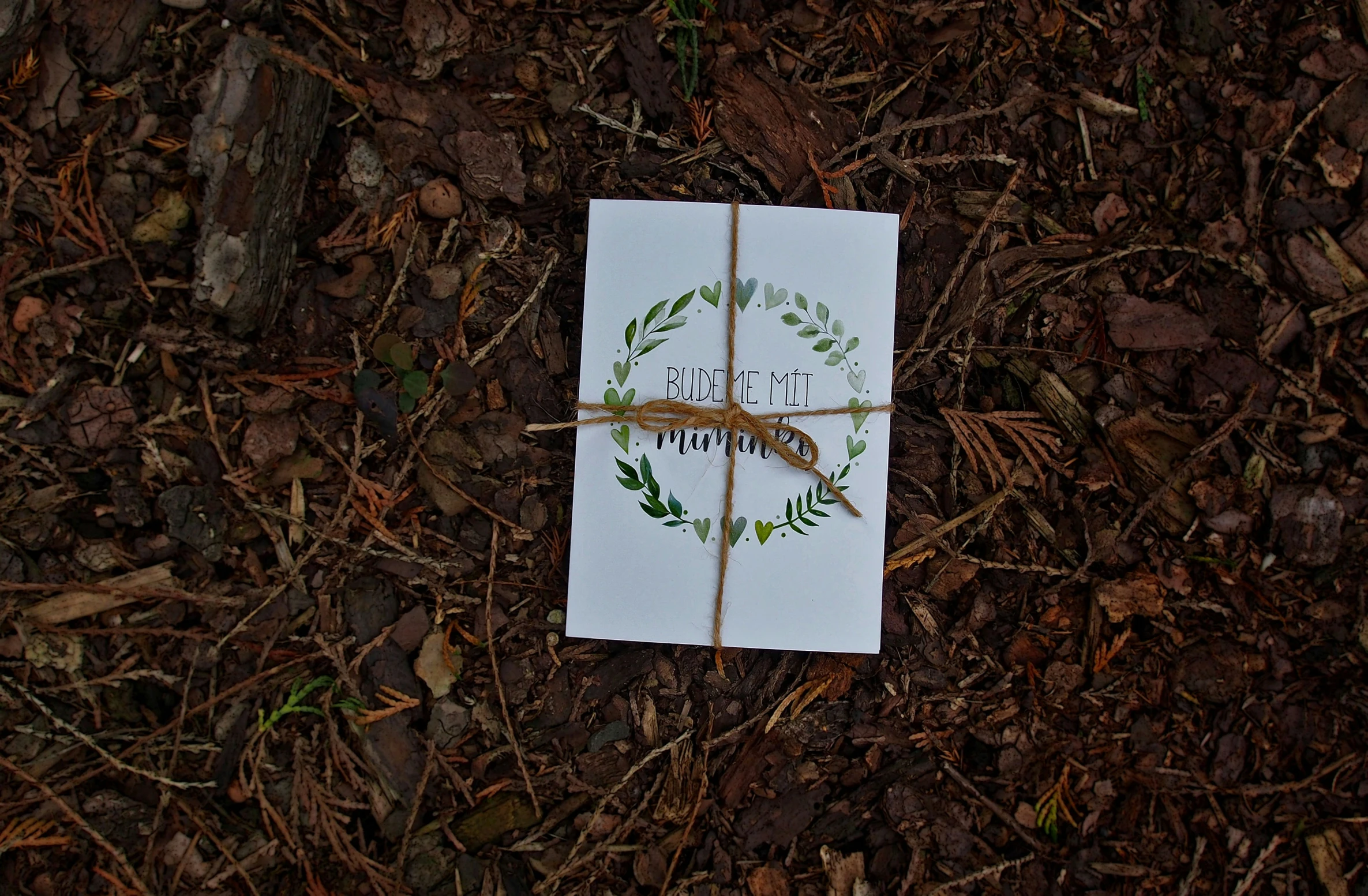 a piece of paper with a name and a flower on it