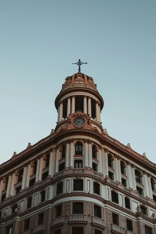 an old building with a clock on the top of it