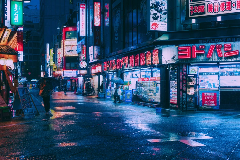 a man walks down the street past neon lit shops