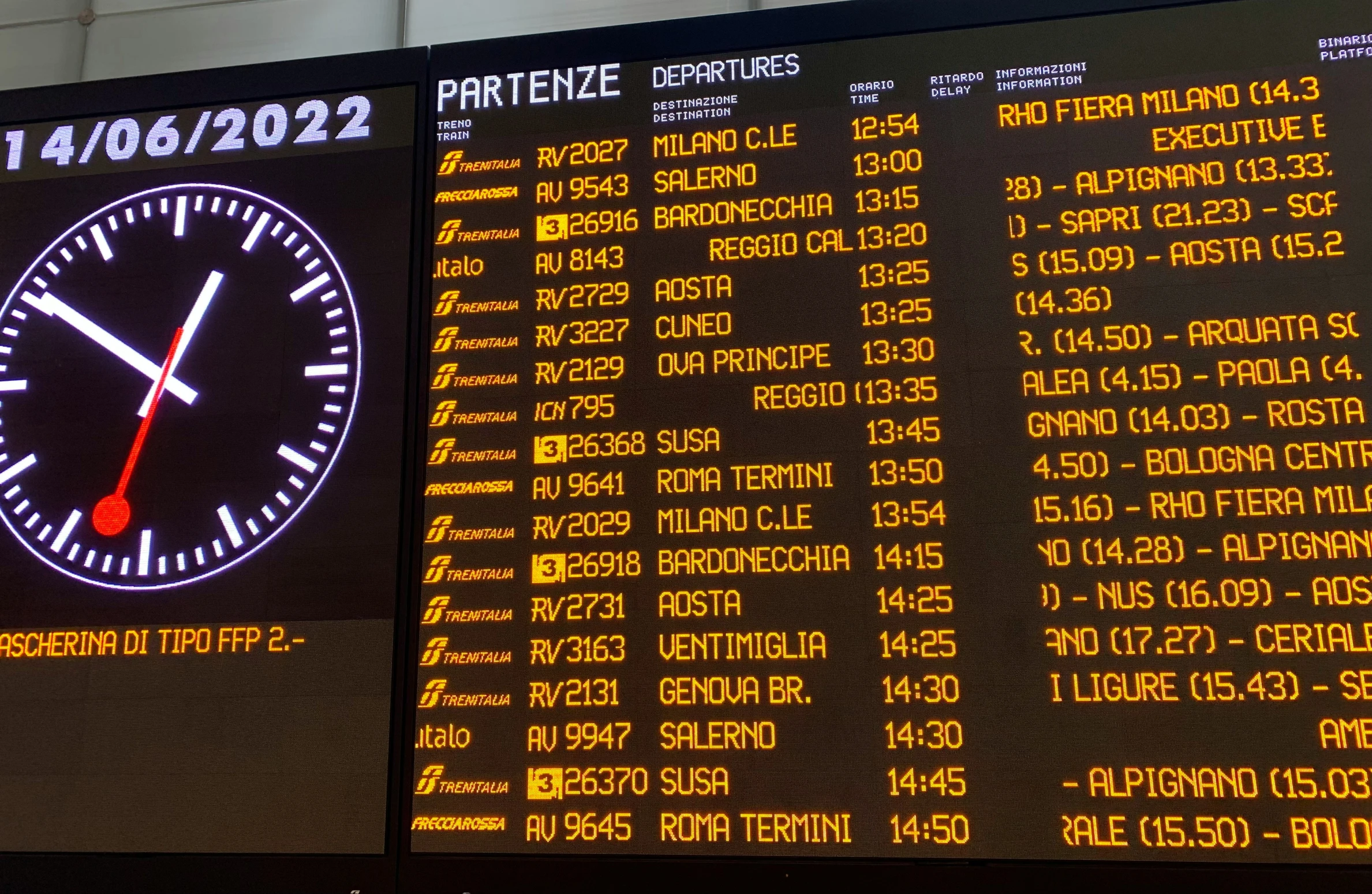 an airport departure sign is lit up with yellow lettering