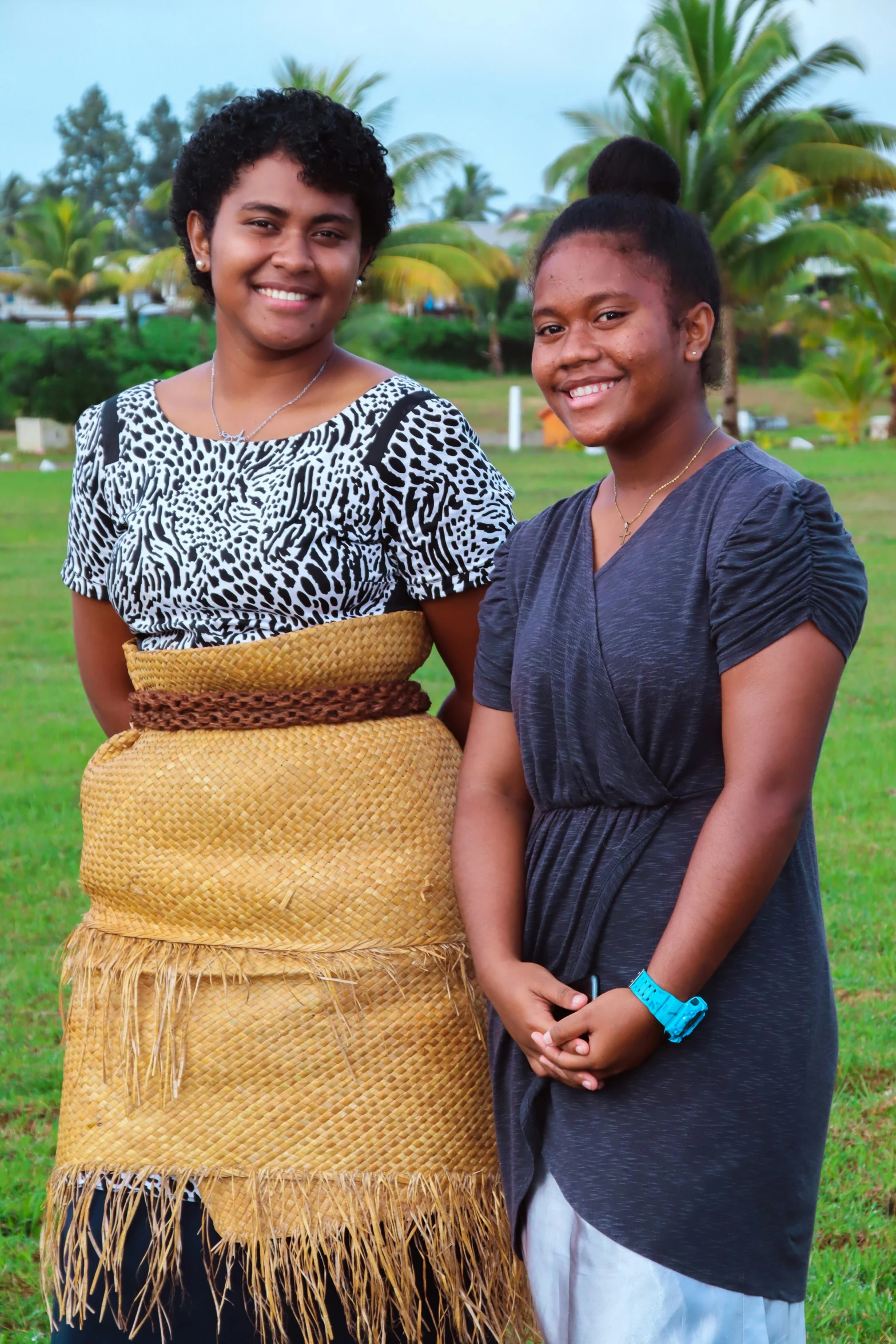 two women in traditional garb standing side by side