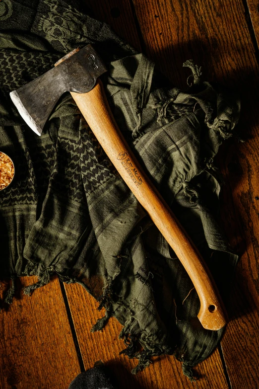 a wooden kitchen knife laying on top of a cloth