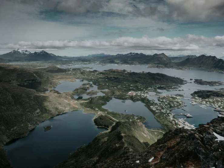 an aerial view of several lakes with mountains in the background