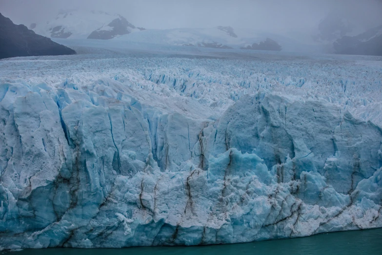 a glacier surrounded by large blue ice and snow