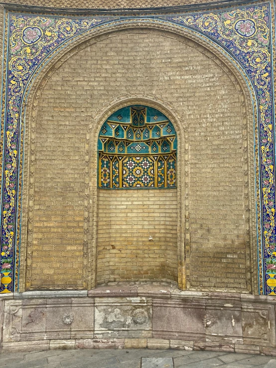 a stone wall with a decorative doorway inside