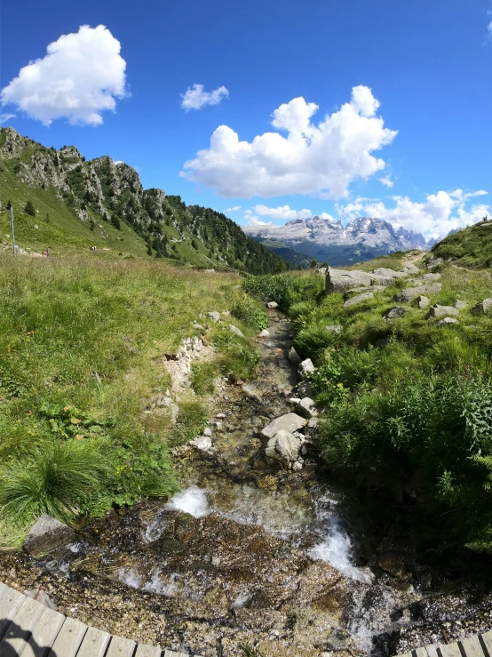 some water and hills under a blue sky