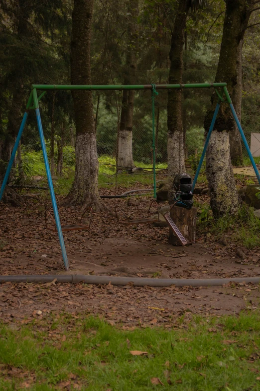 an empty swingset sitting in a park