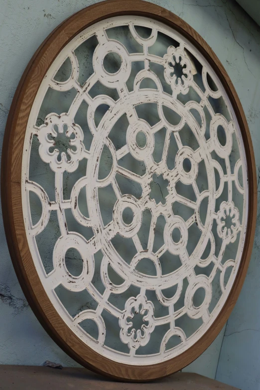 a white circular wooden screen with wood rim